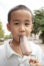 close up face of asian boy eating chocolate icecream with happiness face Royalty Free Stock Photo