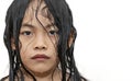 Close up face of Asian child girl on white background, wet face and hair, water drops on face and hair, unpredictable or cold Royalty Free Stock Photo