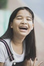 Close up face of asian teenager laughing with happiness emotion