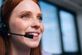 Close-up face of attractive young woman operator using headset during customer support at home office. Royalty Free Stock Photo