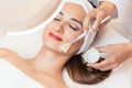 Close-up of a beautiful woman relaxing during facial treatment in beauty center Royalty Free Stock Photo