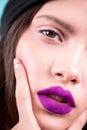 Close up face of a beautiful young brunette woman with professional makeup, well groomed face, purple lips. Fashion, cosmetics, fa Royalty Free Stock Photo