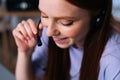 Close-up face of cheerful young woman operator using headset during customer support at home office. Royalty Free Stock Photo