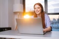 Close-up face of cheerful young woman operator using headset and laptop during customer support at home office. Royalty Free Stock Photo