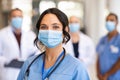 Happy nurse with face mask smiling at hospital Royalty Free Stock Photo