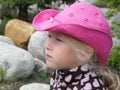 Close-up of the face of a contemplative little girl in a cowboy hat
