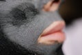 Close-up of a face covered with a clay mask. Mud spa. Royalty Free Stock Photo