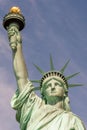 Close-up of the face, crown and hand holding the torch of the Statue of Liberty on a sunny day Royalty Free Stock Photo