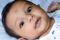 Close up face of cute newborn baby boy smiling in happy mood posing at camera. One month old Sweet little infant toddler Closeup Royalty Free Stock Photo