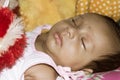 Close up face of cute sleeping newborn baby boy in drowsy eyes sleepy mood lying on bed. Portrait One Sweet little infant toddler