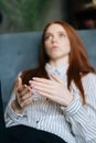 Close-up view of sad red-haired young woman talking about problems at psychologist appointment Royalty Free Stock Photo