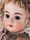 Close up on face of doll in dress and bonnet Royalty Free Stock Photo