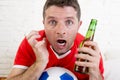 Close up face fan man watching football on tv in team jersey suffering nervous Royalty Free Stock Photo