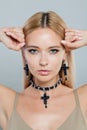 Close up face of fashion jewelry model woman. Lady with fresh clean skin, blonde hair and necklace on her neck Royalty Free Stock Photo