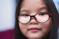 Close-up of the face of a girl wearing glasses to help her see from nearsightedness