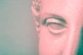 Close up face gypsum copy antique sculpture with craquelure. Red green vaporwave effect. Textured.