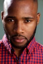 Close up face of handsome black guy against gray wall