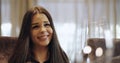 Close up of the face of impressed young brunette woman sitting at the table in restaurant and readding menu.