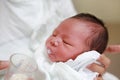 Close-up face of infant drinking milk from glass cup