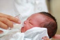 Close-up face of infant drinking milk from glass cup