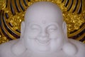 close up face of Katyayana or Gautama Buddha in a Japanese . In Thailand, it is called Phra Sangkajai,laughing Buddha.