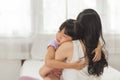 Close up face little daughter sleep embrace her loving mother in a bedroom. Royalty Free Stock Photo