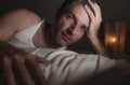 Close up face portrait of sleepless and awake attractive man with eyes wide open at night lying on bed suffering insomnia sleeping Royalty Free Stock Photo