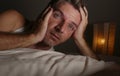 Close up face portrait of sleepless and awake attractive man with eyes wide open at night lying on bed suffering insomnia sleeping Royalty Free Stock Photo