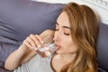 Close up Face portrait of woman drinking water in bedroom. Smiling girl.  portrait Royalty Free Stock Photo