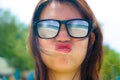 Close up face portrait of young beautiful Asian woman wearing sunglasses with tropical beach sea and sand reflection on the glasse Royalty Free Stock Photo