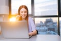 Close-up face of positive young woman operator using headset and laptop during customer support at home office. Royalty Free Stock Photo