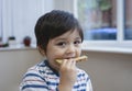 Close up face Preschool boy eating honey on toasted for his breakfast before go to school, Cropped shot Healthy child eating