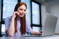 Close-up face of pretty young woman operator using headset and laptop during customer support at home office. Royalty Free Stock Photo