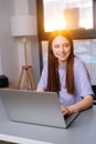 Close-up face of pretty young woman operator using headset and laptop during customer support at home office. Royalty Free Stock Photo