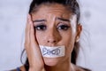 Close up face of sad beautiful woman with taped mouth text no food written Royalty Free Stock Photo