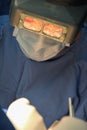 Close-up of the face of a surgeon operating with visual mask and mask cover