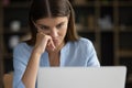 Close up face tired unmotivated female, staring at laptop screen