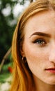 Close-up face of a young ginger ginger freckled woman with red hair and perfect healthy freckled skin Royalty Free Stock Photo