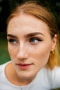 Close-up face of a young ginger ginger freckled woman with red hair and perfect healthy freckled skin Royalty Free Stock Photo