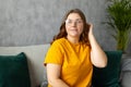 Close up face of young woman in glasses with beautiful smile siting on the sofa couch at home. 30s female rest and spend Royalty Free Stock Photo