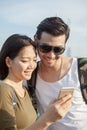 Close up face of younger asian man and woman looking to smart ph Royalty Free Stock Photo