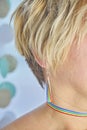 Close Up faceless portrait of blonde woman with rainbow accessories