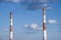 close-up factory brick chimney. two pipes cogeneration plant on the sky background. Ambient air pollution industrial emissions Royalty Free Stock Photo