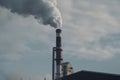 close-up of factory chimney emitting black smoke into the air