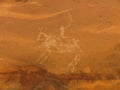 Close-up of faded petroglyph of a rider on a horse, Bhimbetka rock shelter, Madhya Pradesh, India Royalty Free Stock Photo