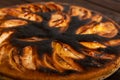 close-up failed apple pie. burnt on top and the dough did not rise during baking.