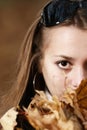 Close-up fall portrait of young girl with foliage Royalty Free Stock Photo
