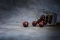 Close-up of fallen glass with dark sweet cherries