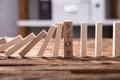 Falling Dominos Stopped By Wooden Blocks Showing Stop Text Royalty Free Stock Photo