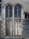 Close-up of exterior stone wall and stained glass windows in the Great Hall of Eltham Palace, England.